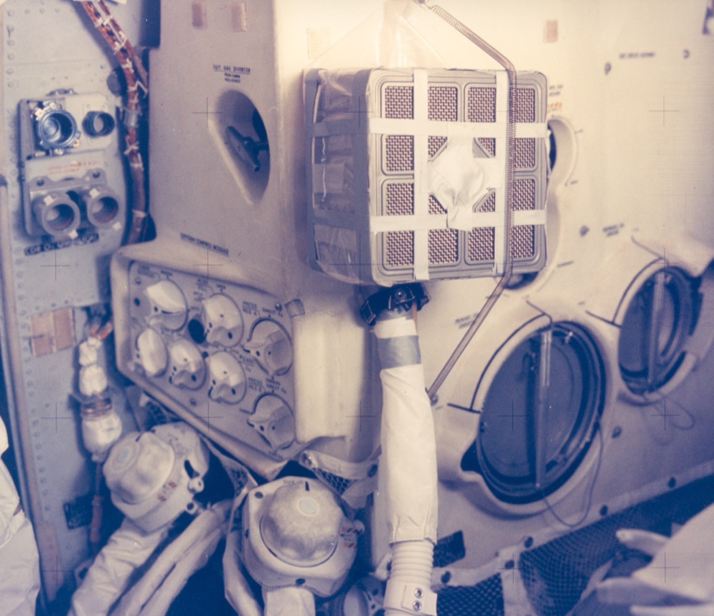 The improvised CO2 scrubber mailbox adapter taped together aboard Apollo 13
